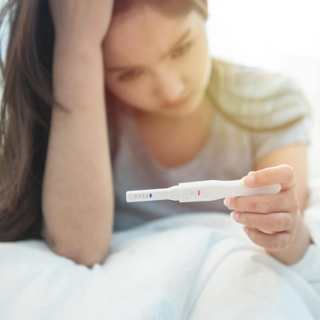 A woman disappointed with pregnancy test result