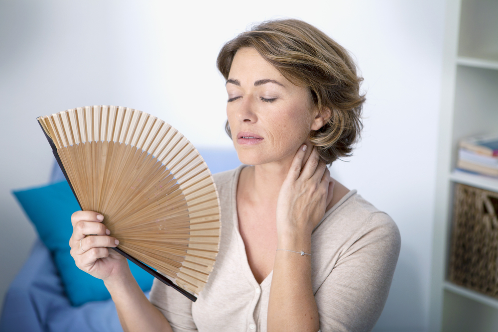 A menopausal woman with a fan